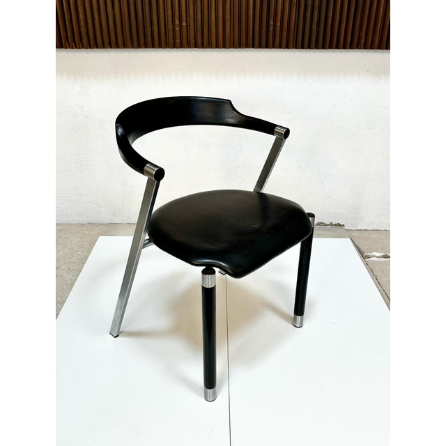 A sculptural and well-proportioned chair made of steel, black lacquered beech, and black leather. Typical of the late...