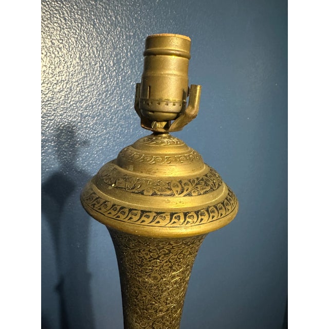 Step into history with this very unique set of Mid Century Era Indian Etched Brass Lamps, a pair that radiates the...