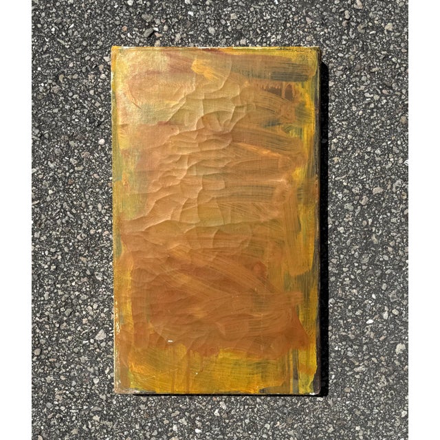 Glowing with quiet intensity, this small abstract painting radiates warmth through its layered washes of yellow and gold....