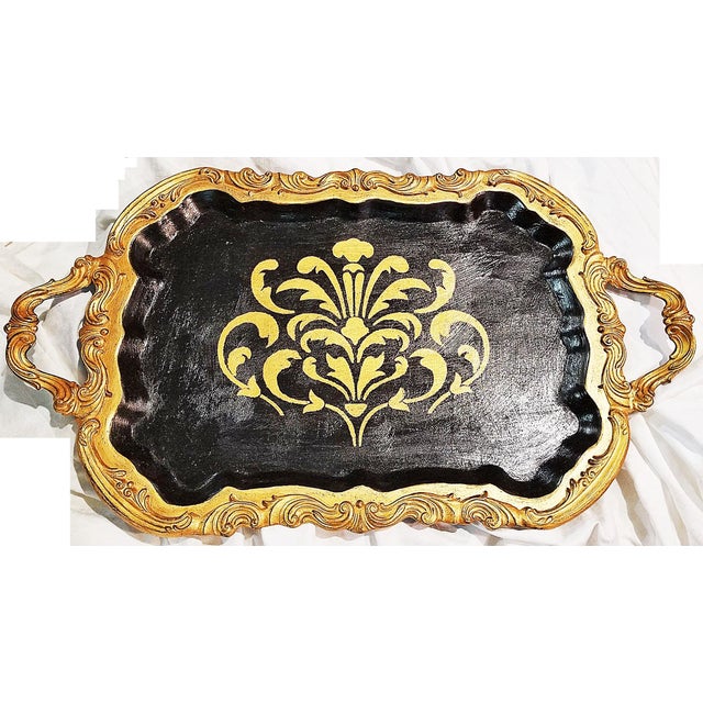Brighten up an event or a room with this 1950s silverplated footed serving tray in a textured black and gold motif with a...