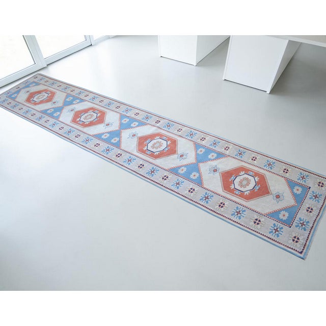 This exquisite hand-knotted runner, originating from the rugged highlands of Eastern Anatolia during the 1980s, represents...
