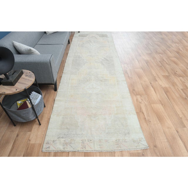 Vintage Hand-Knotted runner rug is a semi-antique vintage area rug. The '70s Eastern region of Anatolia's unique rug is...