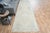 Vintage Hand-Knotted runner rug is a semi-antique vintage area rug. The '70s Eastern region of Anatolia's unique rug is...