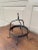 A very nice late 18th century blacksmith handwrought iron game rack with a center ring with six hooks supported by three...
