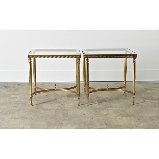 A pair of vintage, midcentury French brass and glass end/side tables in the manner of legendary firm Maison Jansen that...