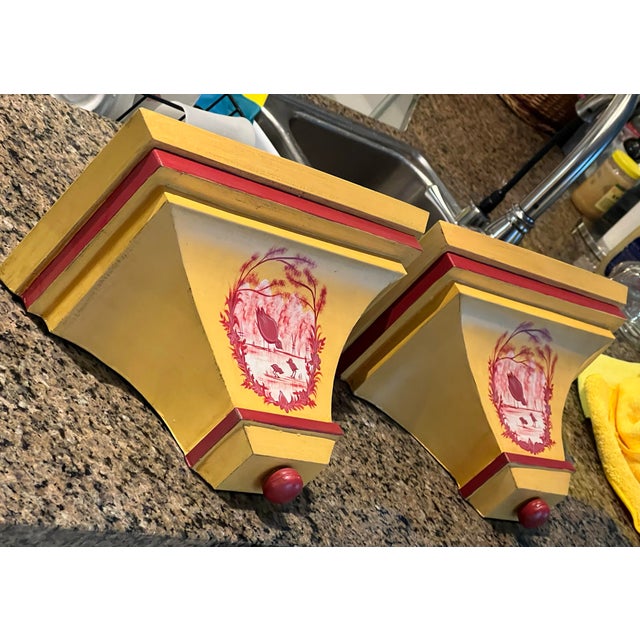 Vintage hand painted yellow wall shelves with lip. There are a ppair of baby birds with their mother painted to the front....