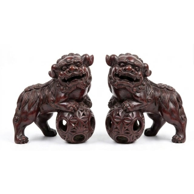 These are Chinese hand-carved wooden Foo dog guardian lion sculptures, beautifully detailed with intricate curly manes and...