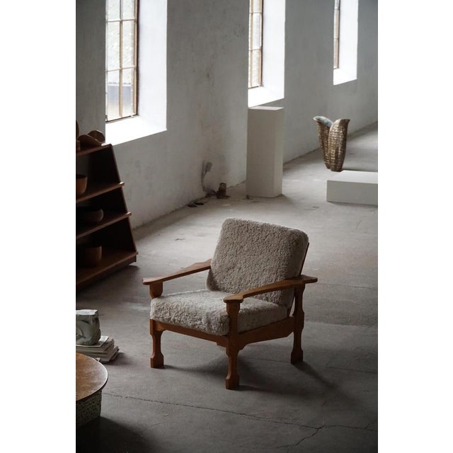 A stunning pair of Danish modern lounge chairs in the style of Henning (Henry) Kjærnulf. Made in oak and reupholstered...