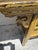 Impressive antique Asian entre table handcrafted in hardwood with two drawers and carved spandrels painted in a mustard...