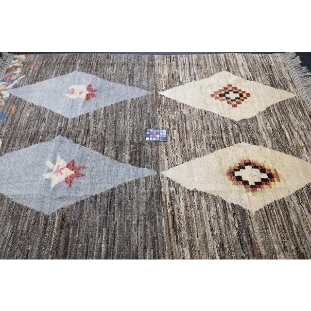 Comprising both the nomadic Berber rugs of the Atlas Mountains, with very thick piles, coarse knotting and limited...