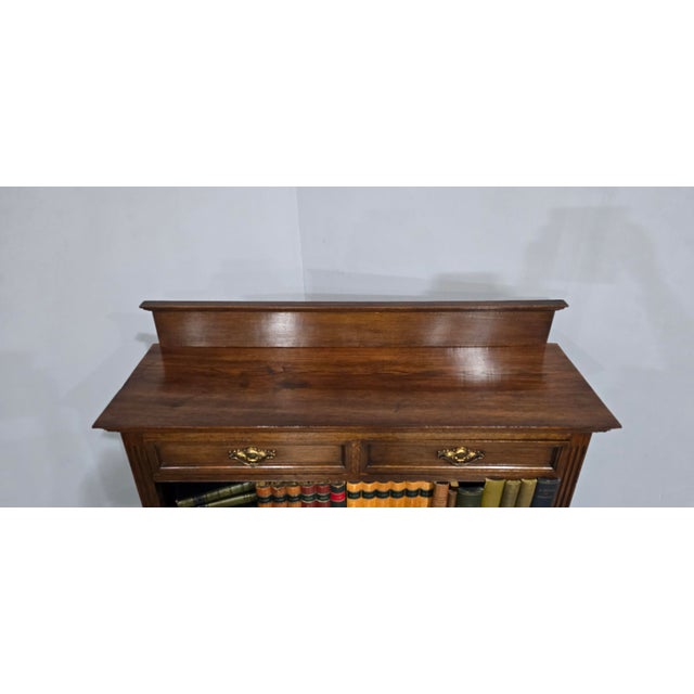 A very good open adjustable bookcase in oak, two drawers to the top three shelves,, upstand to the back. excellent colour...