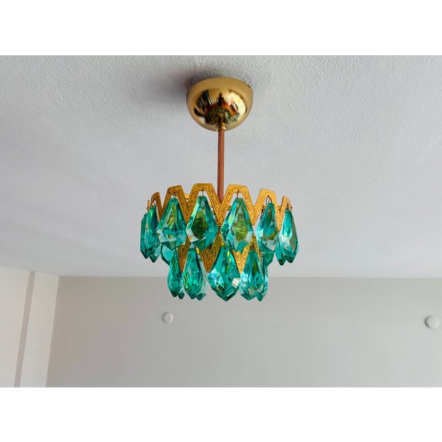A captivating statement lighting fixture, this compact 1-light mini chandelier pairs solid polished brass with hand-...