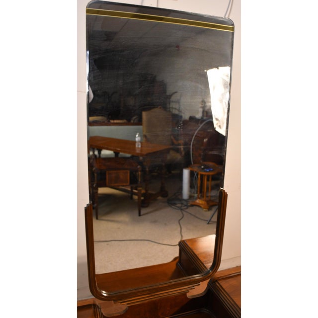 We are pleased to offer this beautiful Art Deco vanity and mirror, from the 1950s. This vanity is made of Walnut wood...