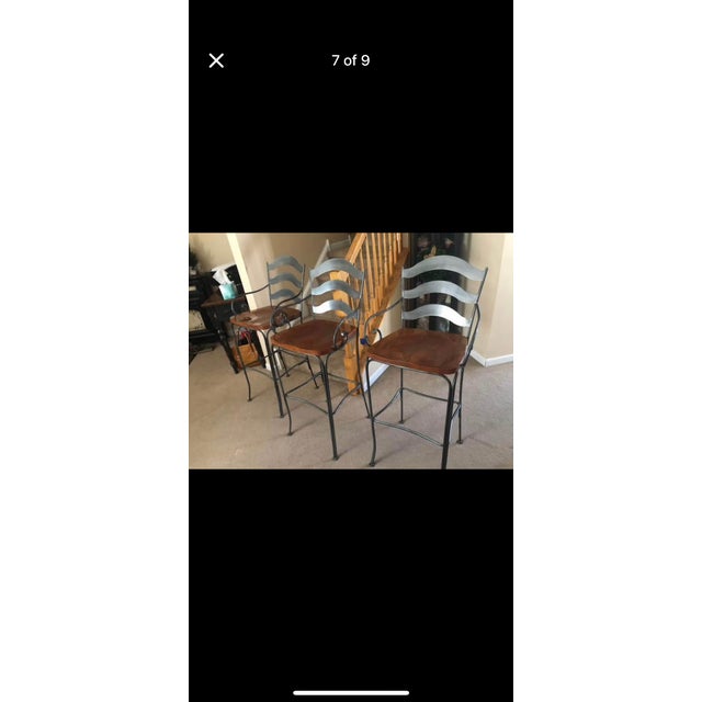 Ethan Allen brand stools were made in America. The are very solid heavy stools. Beautiful accents of iron and wood.