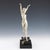 An art deco patinated bronze sculpture of a nude woman with arms outstretched in a striding pose. Set over a marble and...