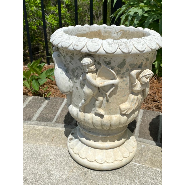 Pair of cast stone Neoclassical Urns. Great patina, weigh approximately 21 lbs each. Very good condition for their age