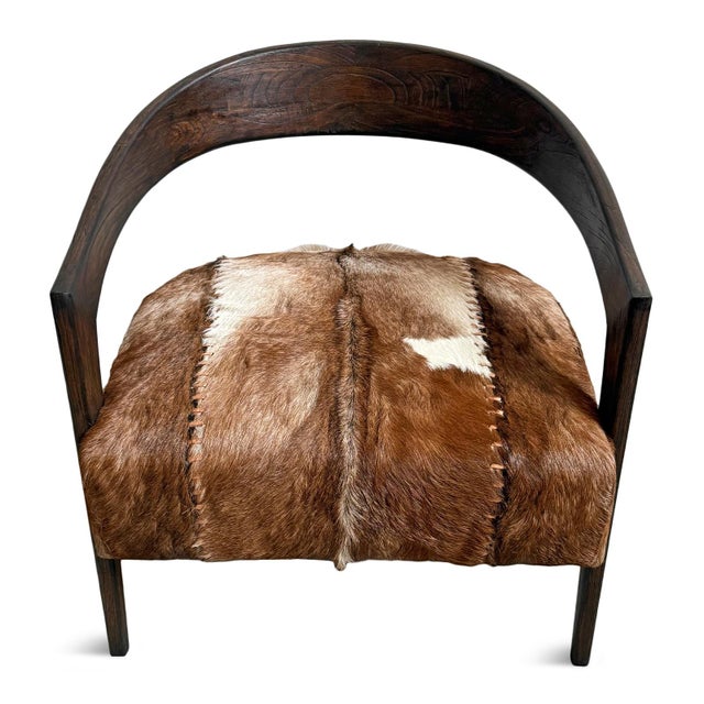 Horseshoe wood frame arm chair with goat hide seat. Each hide varies in exact natural pattern. Seat height is 19".