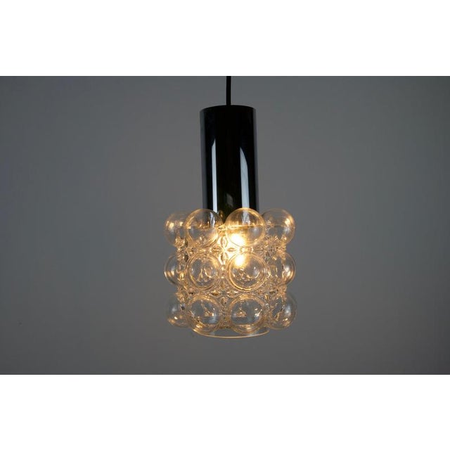 A beautifully textured bubble glass pendant lamp designed by helena tynell and produced by glashütte limburg in the 1960s....
