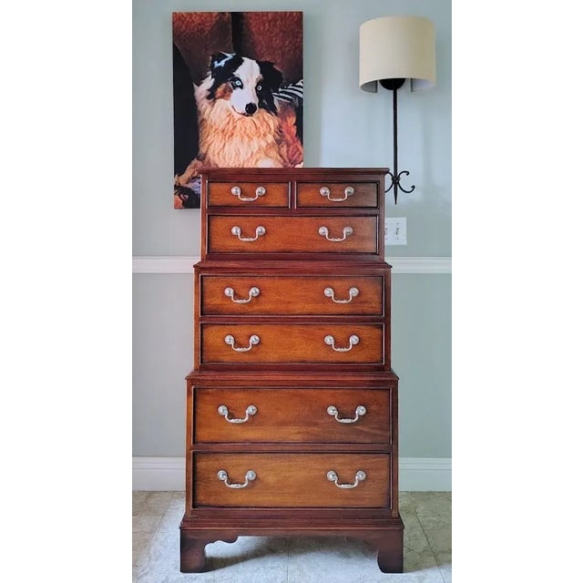This 3 tier mahogany lingerie chest is made by Ethan Allen in the Newport Collection. It has 7 drawers with brass handles...