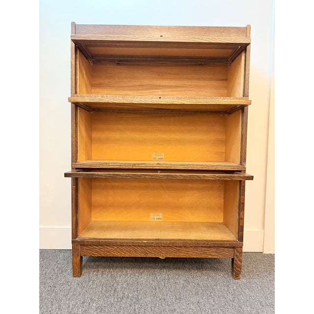 Family heirloom. Three separable bookcase sections plus top and bottom pieces. Bottom bookcase is slightly taller than the...