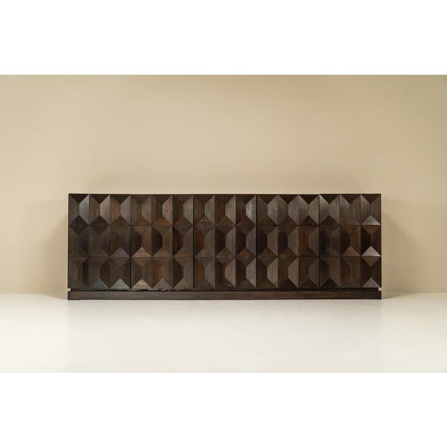 A bold silhouette with sculptural appeal, this Brutalist sideboard in solid oak anchors a room with confidence and quiet...