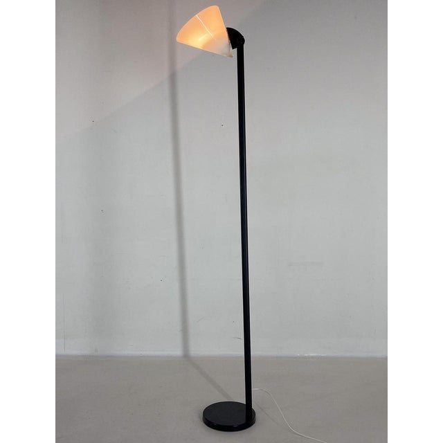Italian vintage floor lamp with black metal base and Murano glass shade. The lamp has been newly sprayed. It has an...
