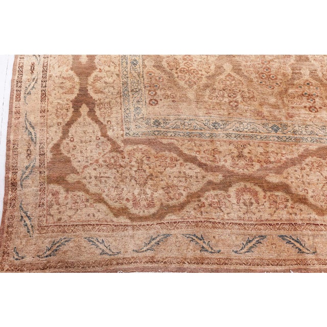 An early 20th century Persian Tabriz rug, the striated light brown field with staggered diamond medallions overall...