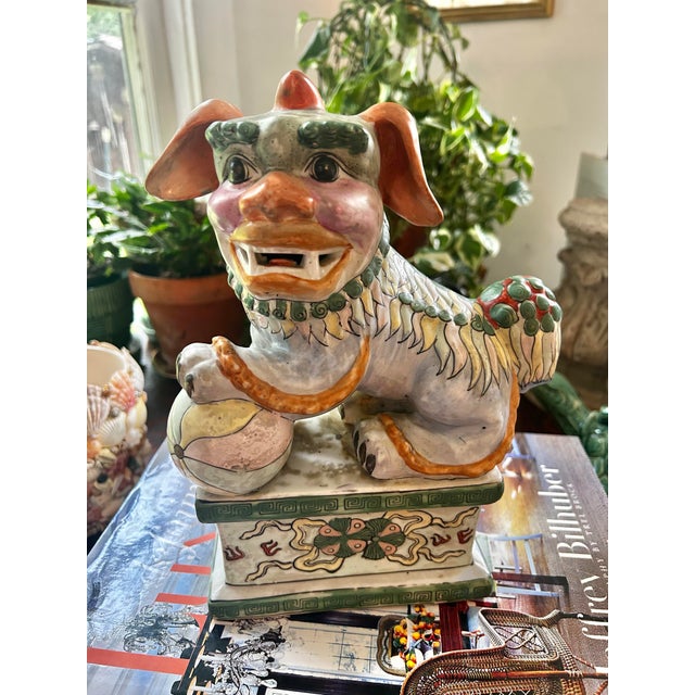 This vintage Chinese export porcelain Foo Dog (Temple Guardian Lion) is painted in a traditional famille verte-inspired...
