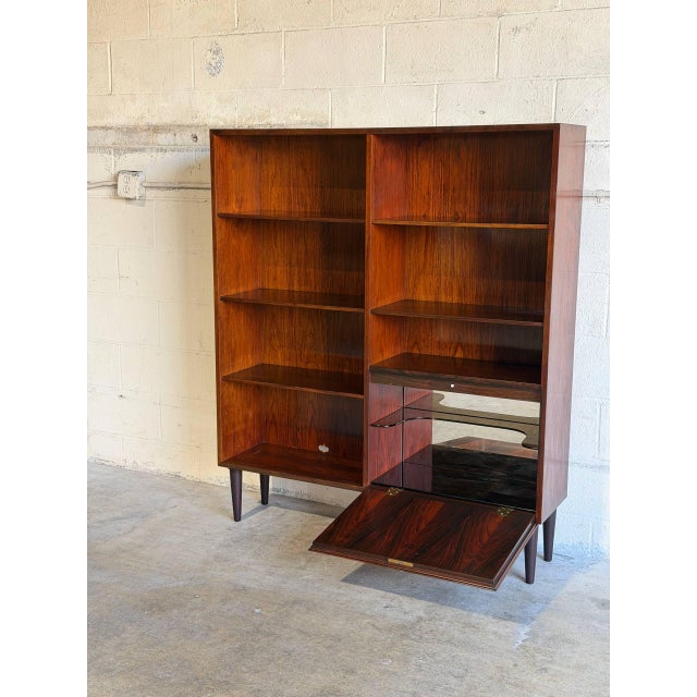 Expertly crafted in Denmark, this open-shelf bookcase features a lower lockable cabinet section with a drop-down door,...