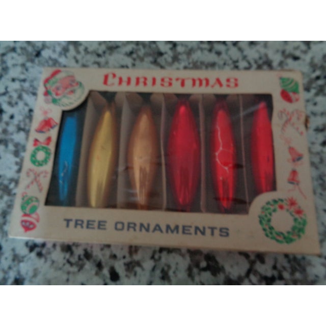 Mid Century Christmas tree ornaments. Elongated and in several colors. A real vintage look to your tree. Comes in its...