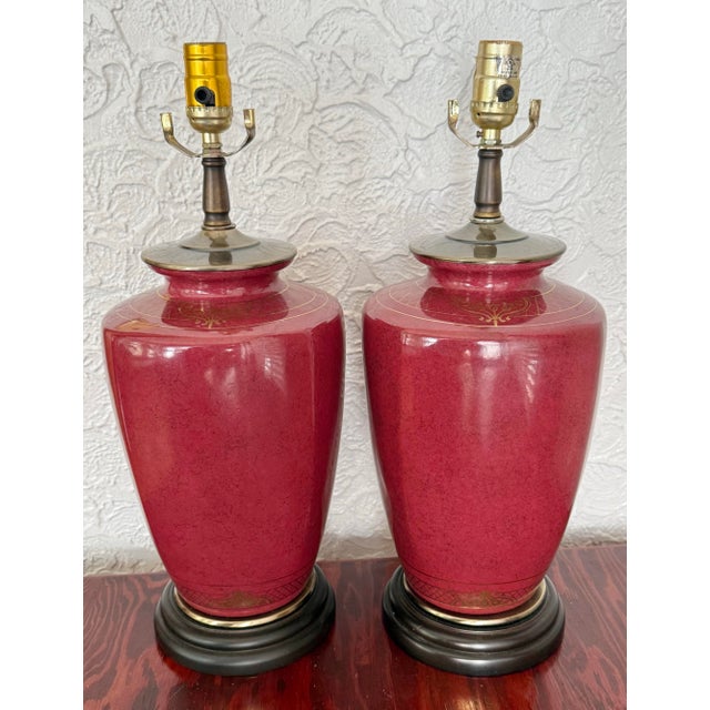 Pair of oxblood red glazed ceramic table lamps. The glaze is a deep red with a subtle dark speckle, in the spirit of...