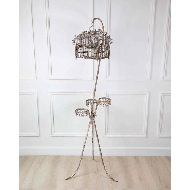 A charming 20th century French birdcage-form plant stand featuring beautifully weathered original paint and delicate...
