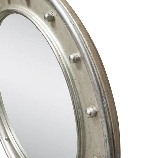 Neoclassical Regency Empire style handcrafted mirror. Round hand carved wooden structure with silver foiled finish, Spain,...