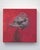 The artwork features a striking depiction of a stylized animal head, rendered in rich, vibrant hues against a deep red...