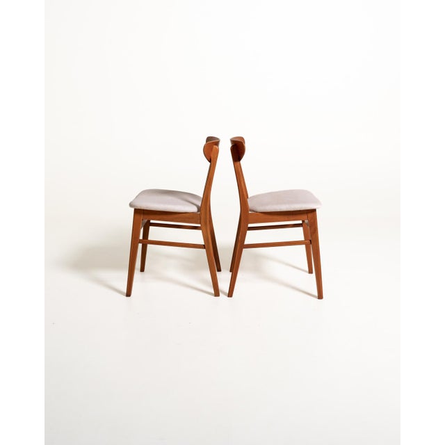 Set of four chairs with a beech frame and curved teak backrest, seats reupholstered in washable ice gray fabric. Model...