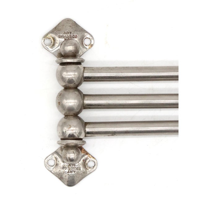 Vintage wall mounted towel bar with three swing out arms in nickel plated brass. Wall brackets on top and bottom, with two...