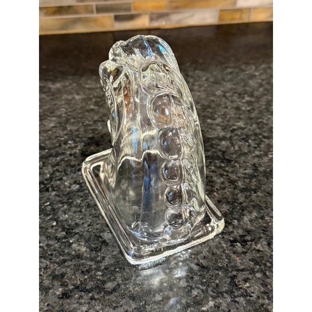 Offering a vintage clear pressed-glass horse head commonly used as a book end or paperweight. Manufactured by the Federal...