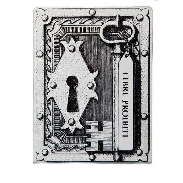 Fornasetti - Libri Proibiti Bookends, Italy 1950's. Pair of hand silkscreened metal bookends is embellished with the Libri...