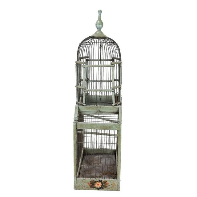 An exceptional 34-inch domed Victorian wire birdcage in an oxidized celadon green, featuring a hand-painted wooden gallery...