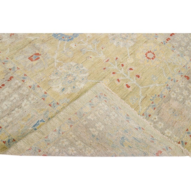 Beautiful modern Sultanabad hand-knotted wool rug with a yellow color field. This rug has a tan designed-frame with...