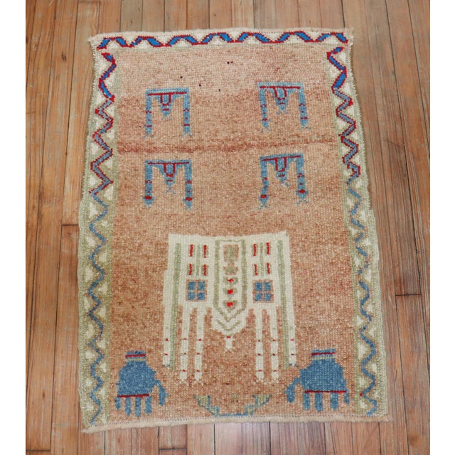 Mid 20th century anatolian rug with a obscure design. Look at the 2 hands on the 1 end
