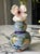 A finely detailed petite double gourd vase crafted in traditional cloisonné over copper. The surface features a pale...