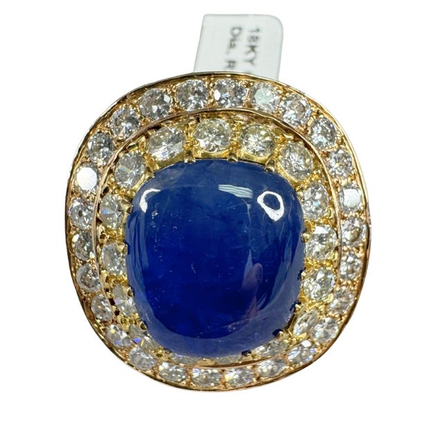 Centering a 19.49 carat natural Burmese blue sapphire, this impressive cocktail ring features a cushion-cut gemstone. The...