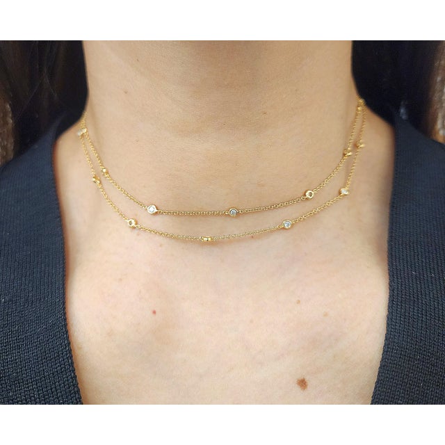 This elegant necklace showcases a harmonious blend of luxury and modern design. Featuring 0.98 ct round-cut natural white...
