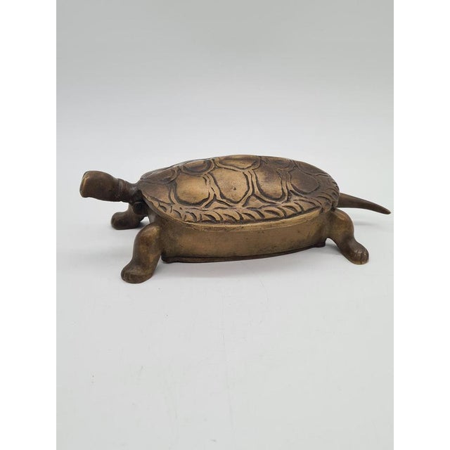 A decorative brass box shaped like a turtle. This piece combines practicality with decorative appeal, making it an...