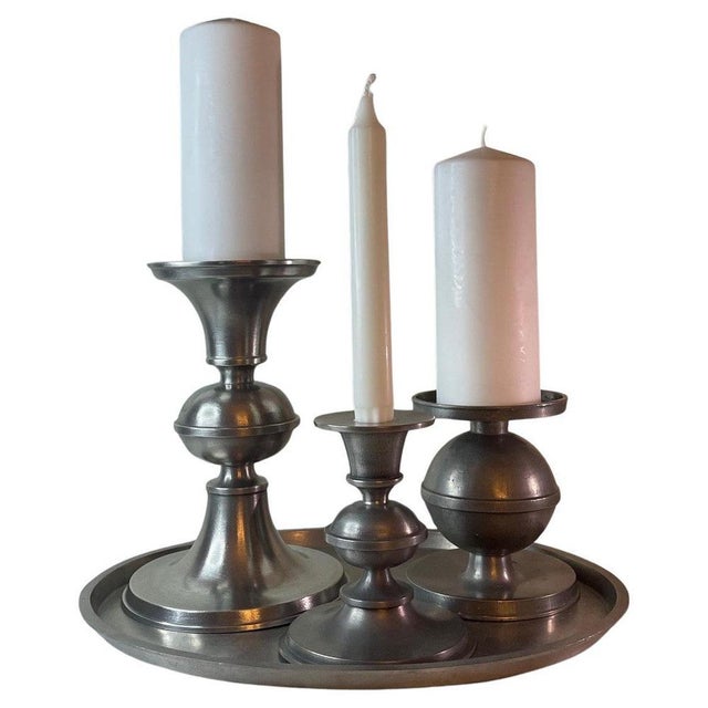 A refined and cohesive Swedish pewter candlestick ensemble designed by Edvin Ollers and produced by Schreuder & Olsson,...