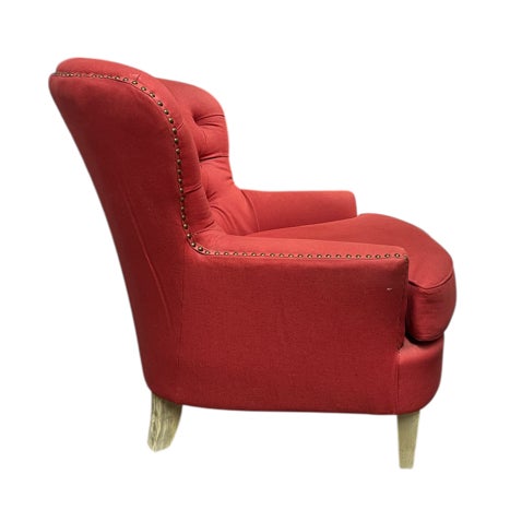 This is an oversized barrel-back upholstered club chair with a continuous, rounded back featuring diamond-button tufting...