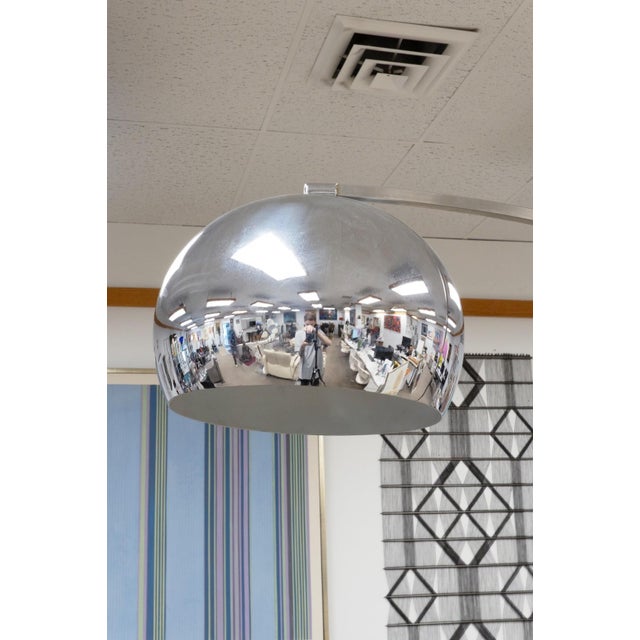 A quintessential example of mid-century modern design, this Arco-style floor lamp features a striking chrome globe shade...