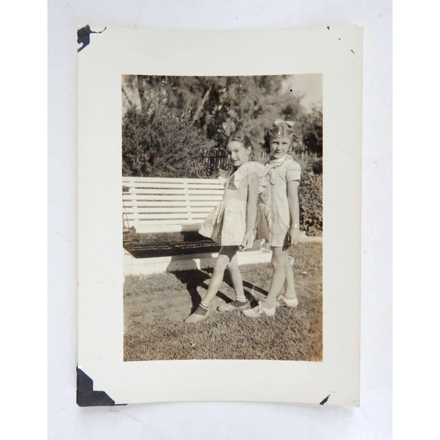 Mid century snapshot of two young girls stepping in sync with a dance move. Stamp on back, Scotts Studio Hondo Texas, 3" x...