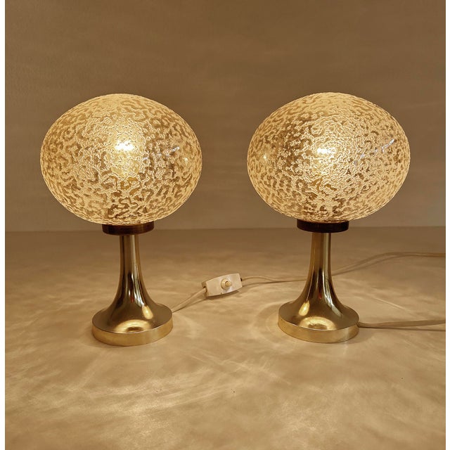 Pair of vintage space age table lamps featuring an amber tint cocoon like globe glass shade wiith sprinkled structure on...